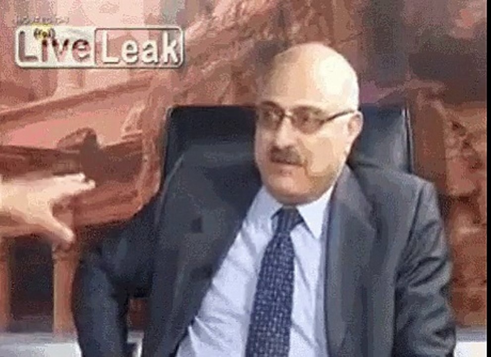 Angry Syrian opponents fight over a table.