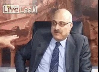 Angry Syrian opponents fight over a table.