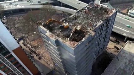 Excavators work on top of high building in central China