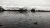 Cool slow motion footage of rain hitting a winter lake