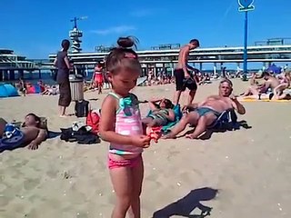 Kids playing on the beach . They making ice cream and cakes from sand