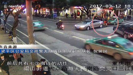 Woman throws bank notes on road in China