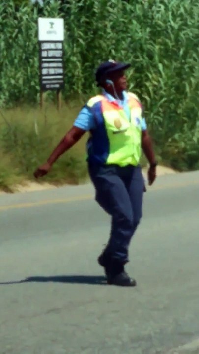 Une agent de police gère le trafic routier en dansant