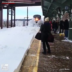 Watch this train blast a bunch of commuters with snow in slow motion