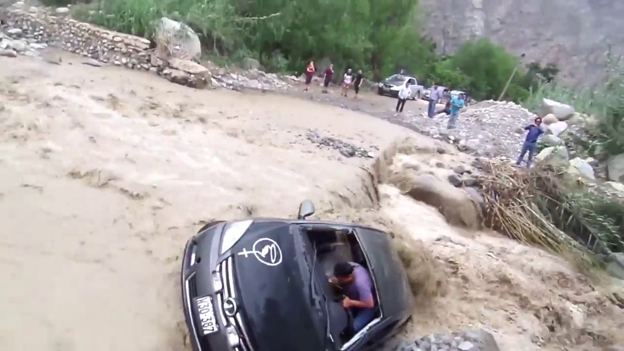 Un idiot traverse en voiture une rivière en crue