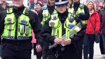 Police officers pay respect to terror victims and fallen colleague outside Parliament