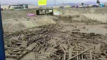 Peru flooding woman scrambles out of vast mudslide