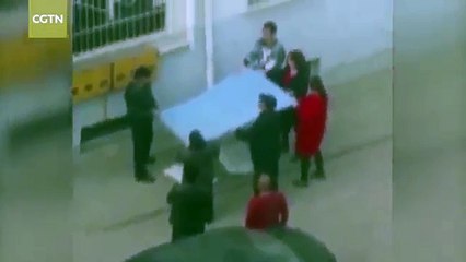 Chinese man uses crane to save girl hanging from window