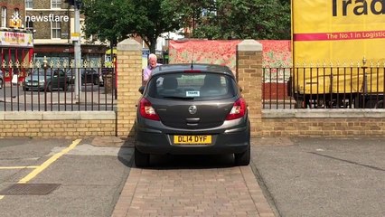 Driver tries to squeeze car through extremely tight gap