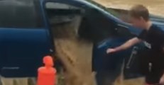 Floodwaters Flow Through Swamped Car in Queensland