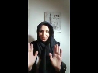 A girl takes off her veil after she arrived in Germany