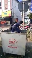 Poor children search valueable things from basket