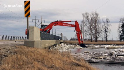 Digger used to clear out 'ice jams' in Manitoba