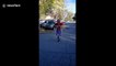 Youngster uses skipping rope while bouncing on a pogo stick