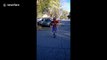 Youngster uses skipping rope while bouncing on a pogo stick
