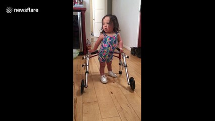Toddler with Down's syndrome uses walker for the first time