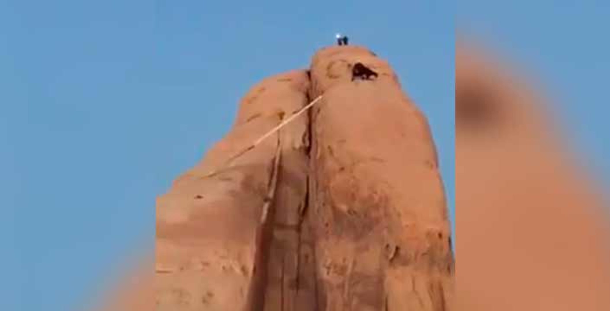 Saudi fire fighters rescuing goats that got stuck in a high big Rocky Mountain