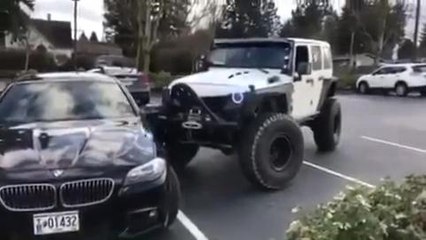 Jeep pushes BMW into parking space
