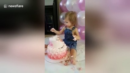 Baby girl destroys birthday cake