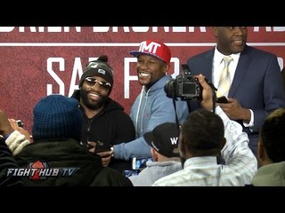 Floyd Mayweather and Adrien Broner laughing and hugging after press conference