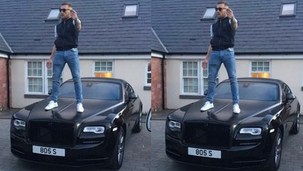 Conor McGregor poses on top of his £240,000 Rolls-Royce Wraith