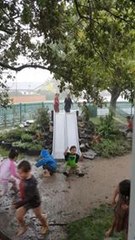 Children Play in Mud Puddles as Severe Weather Lashes New Zealand