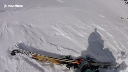 Snowboarder narrowly escapes being swiped by an avalanche