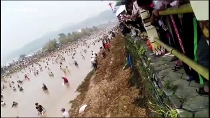 Tens of thousands of people catch fish in river