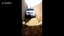 Car gets stuck in narrow alley