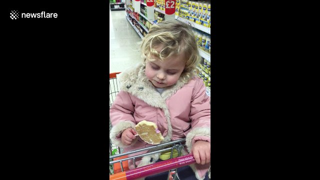 Sleepy toddler struggles to stay awake while eating lollypop
