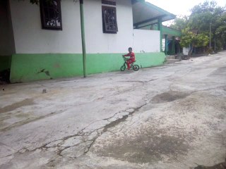 Small children while playing green bikes