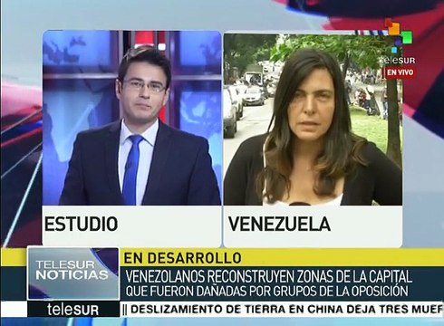 Venezolanos reconstruyen edificios vandalizados por opositores
