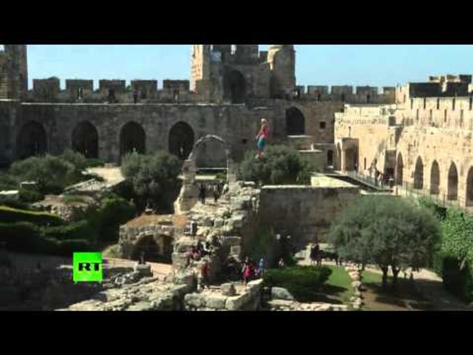 Daredevil performs thrilling splits above the ruins around Tower of David in Jerusalem