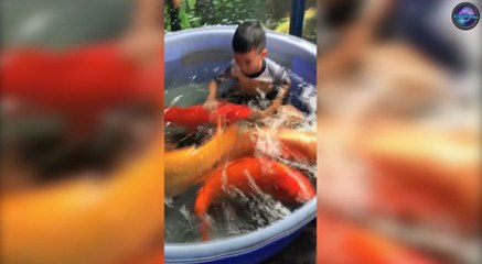 Two Brothers Sitting In Plastic Tubs Filled With Carp
