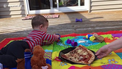 Parents use pizza to motivate their baby to crawl