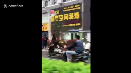 Fitness fanatic does yoga while driving a scooter
