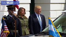 Watch out behind you! The moment Donald Trump crept up behind a saluting Marine and patted him on the back