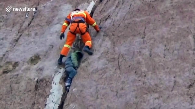 Firefighters rescue a boy stuck in crevice on sheer cliff
