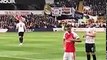 Mesut Ozil rubbing his Arsenal badge in front of abusing Spurs fans