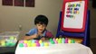 Learning ABC by matching surprise eggs with fridge letter magnets-KvLqAu