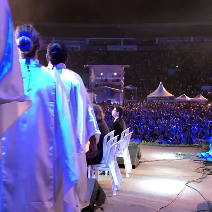 Hungry people worshiping God in the rain. Ps Benny Hinn