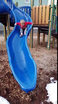 Aden and Ethan playing on the slides monster trucks