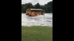 Louisiana School Bus Drives Down Flooded Street, Gets Stuck
