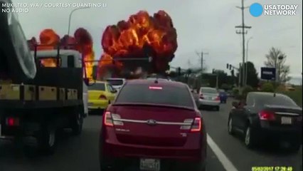 Fireballs erupt as plane crashes onto street