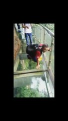 Frightened tourists on a glass bridge in China