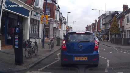 Woman takes a tumble at side of road