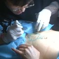This tattoo artist is covering up c-section scars [Mic Archives]