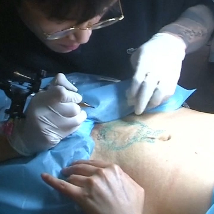 This tattoo artist is covering up c-section scars [Mic Archives]