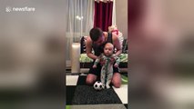 Adorable baby can't walk but loves 'playing' football