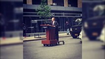 Melissa McCarthy cruises through NY as Sean Spicer on motorised podium